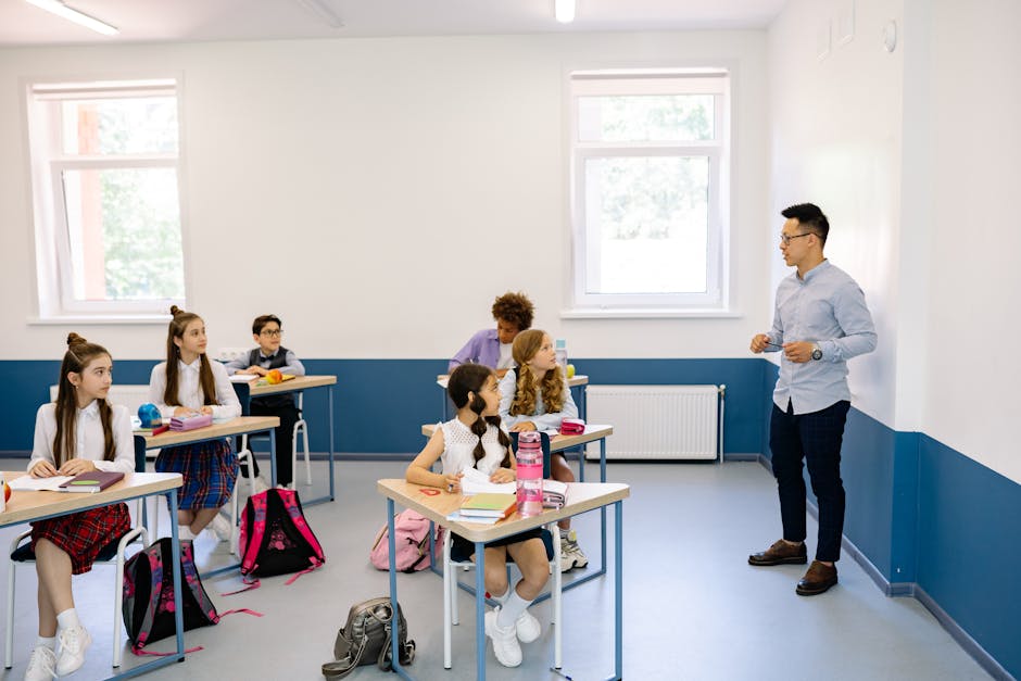 Students attentively listening to a teacher during a classroom lesson