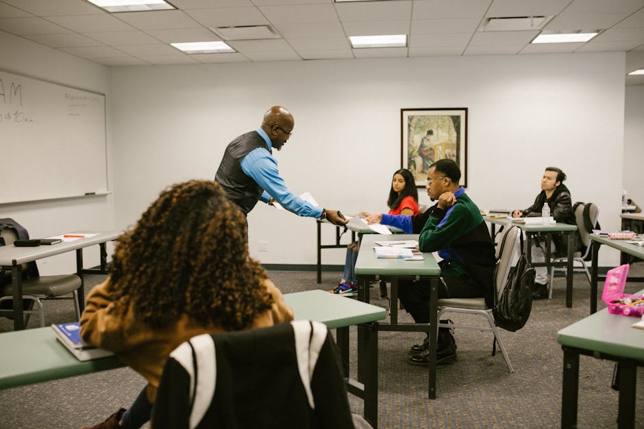 College classroom scene with diverse students and a teacher distributing papers, promoting education